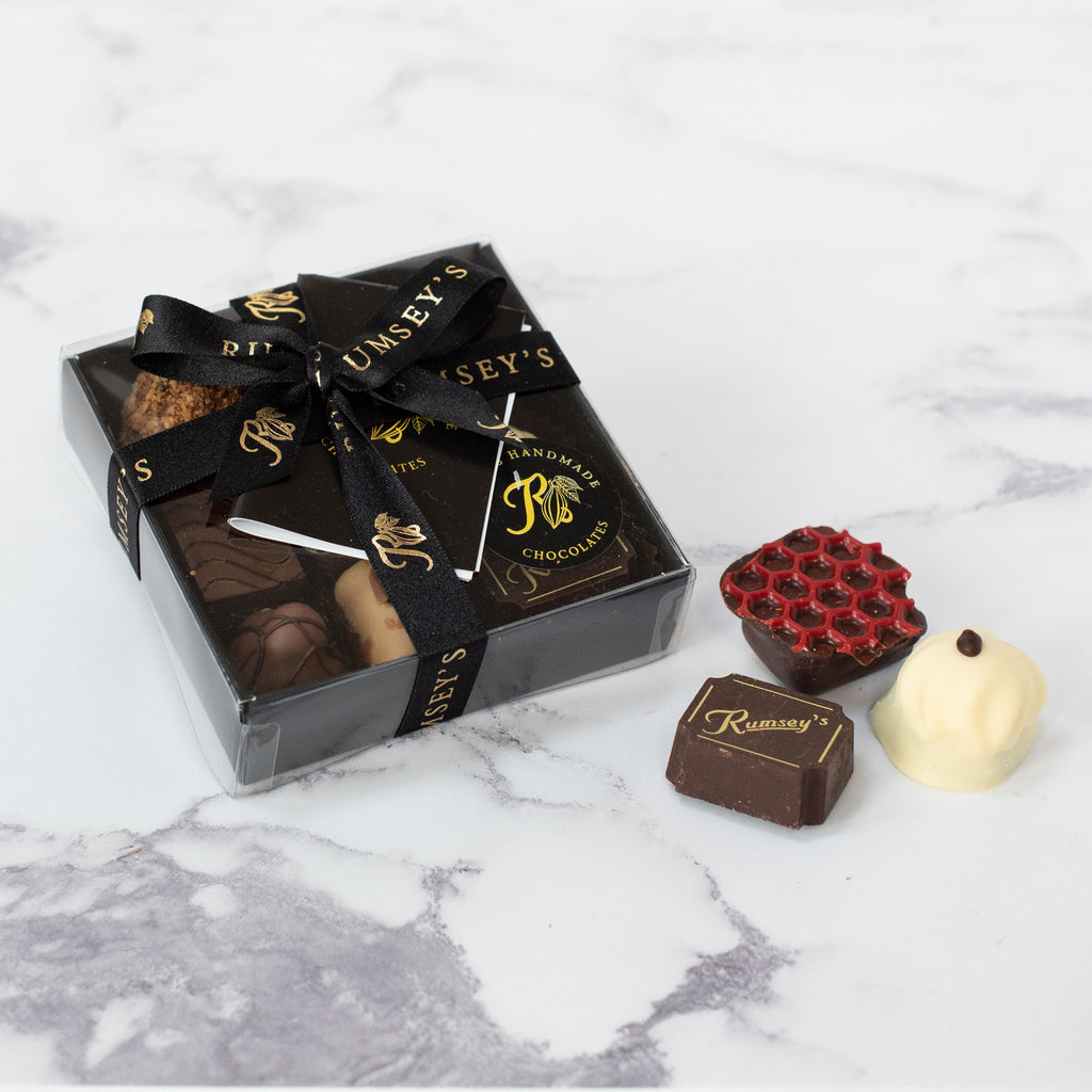 Chocolate box containing 9 truffles hand-wrapped and handmade milk white and dark chocolates 