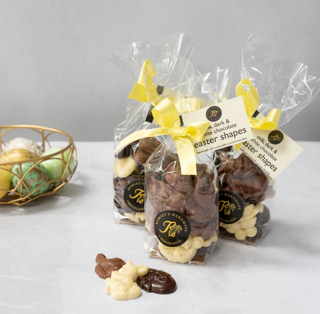 Bag of handmade Easter chocolate shapes including egg, chicks, rabbits, sheep, in milk white and dark chocolate 