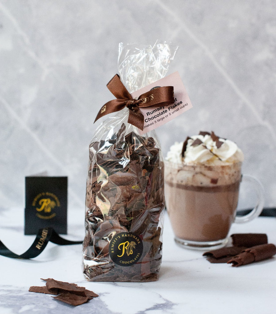 A bag of artisan hot chocolate flakes hand wrapped and tied with brown ribbon